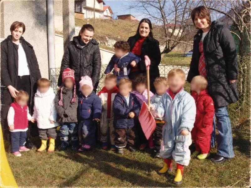 Teachers and children of the Montessori preschool outdoors