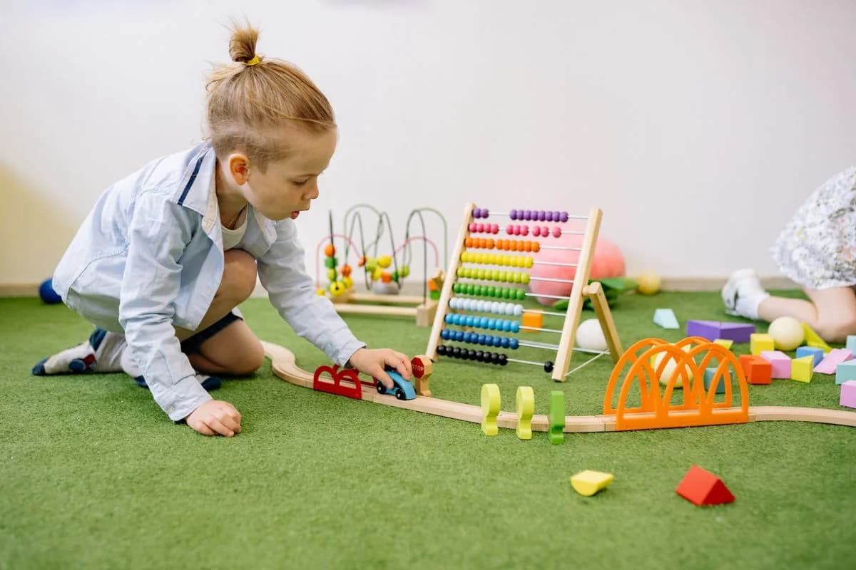 Child playing with wooden toys in the classroom
